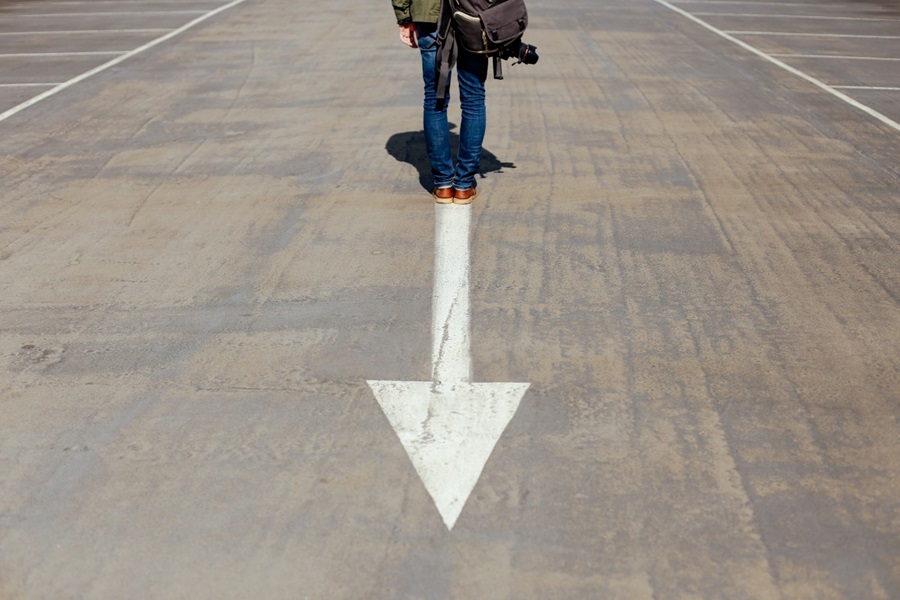 Person standing on arrow