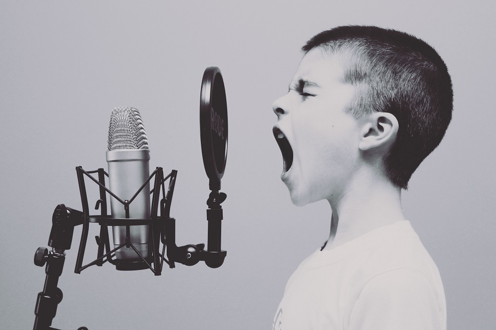 Boy shouting into microphone