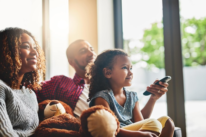 Family watching TV at home