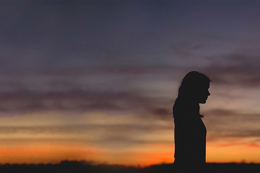 woman silhouette over sunset background