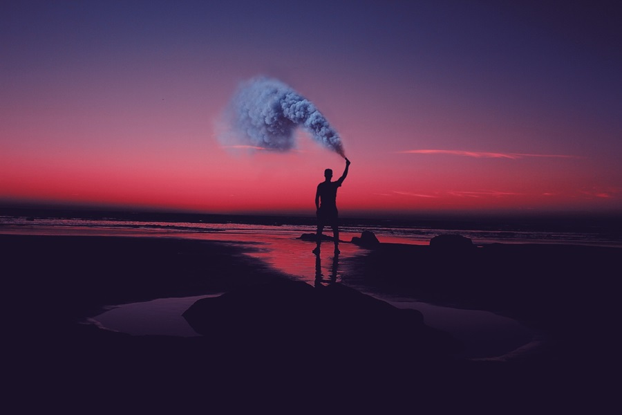 Person with smoke trail on beach