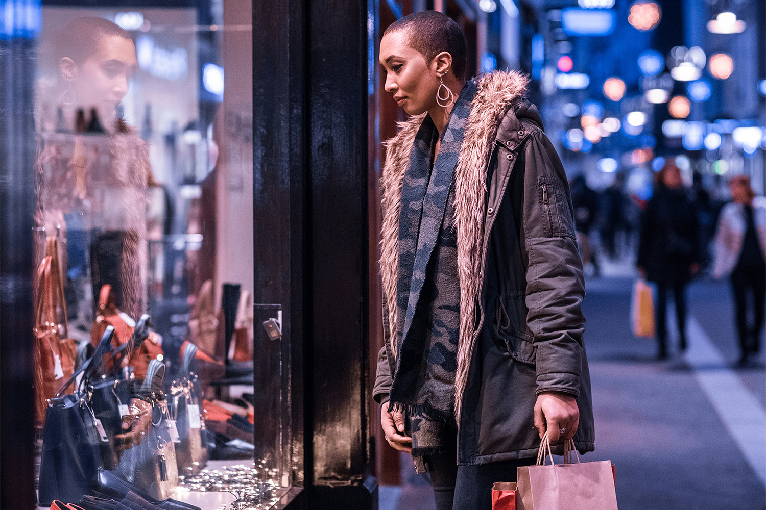 Woman looking at display in shop window