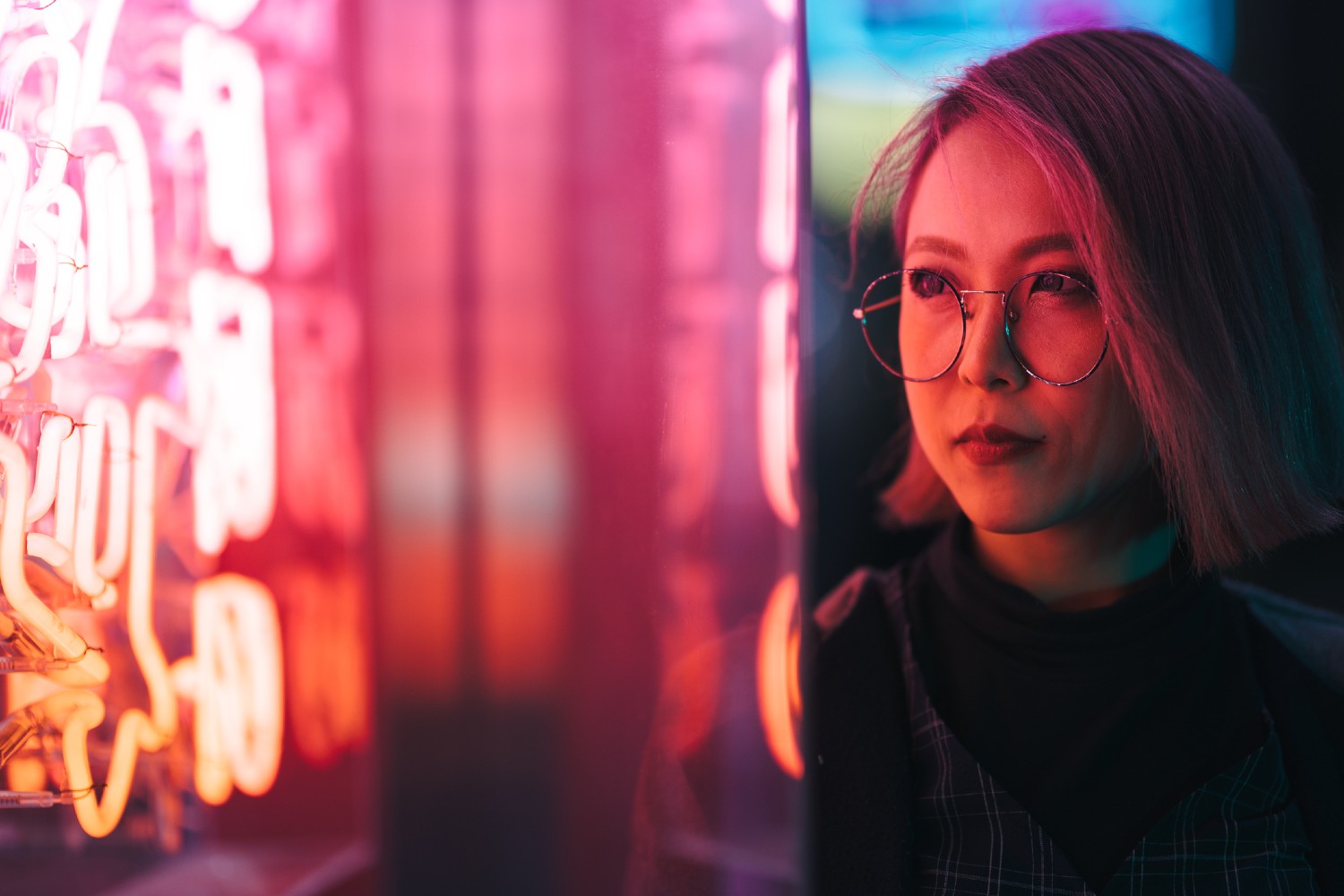 Woman next to pink light