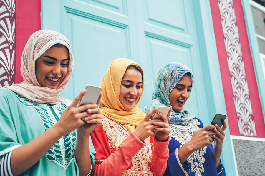 Women in hijab using smartphones