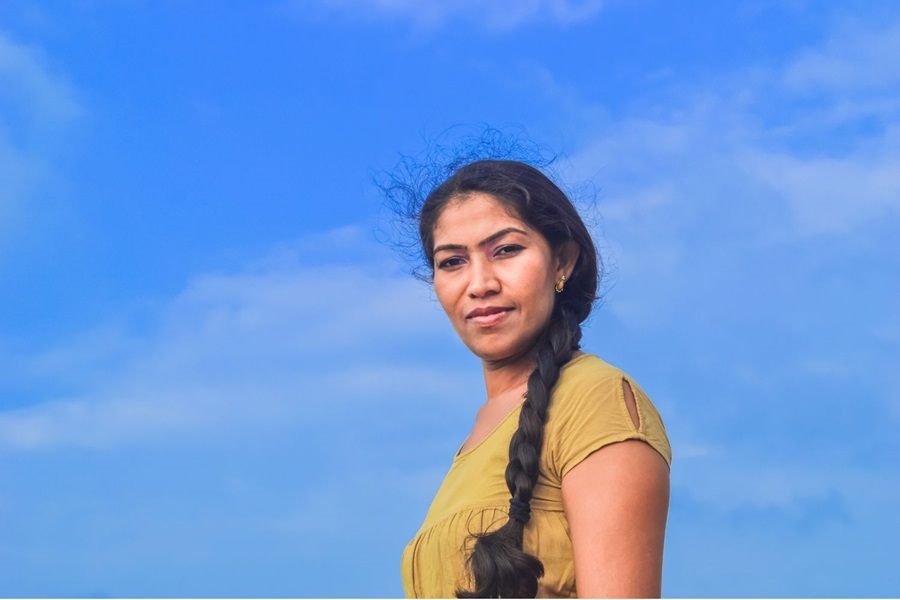 Woman in Sri Lanka against blue sky