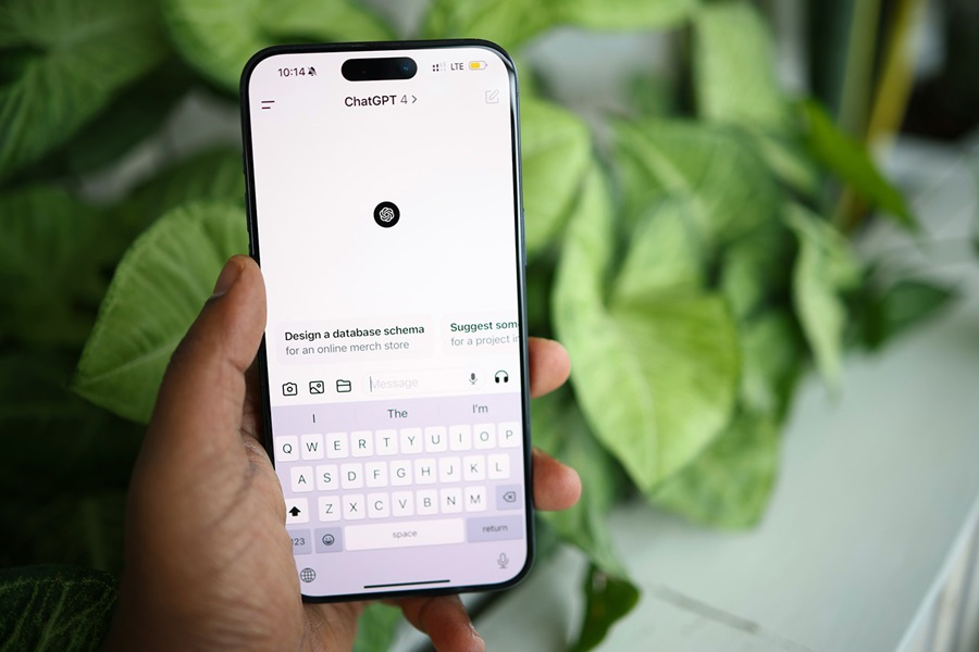 Hand holding phone showing the ChatGPT app