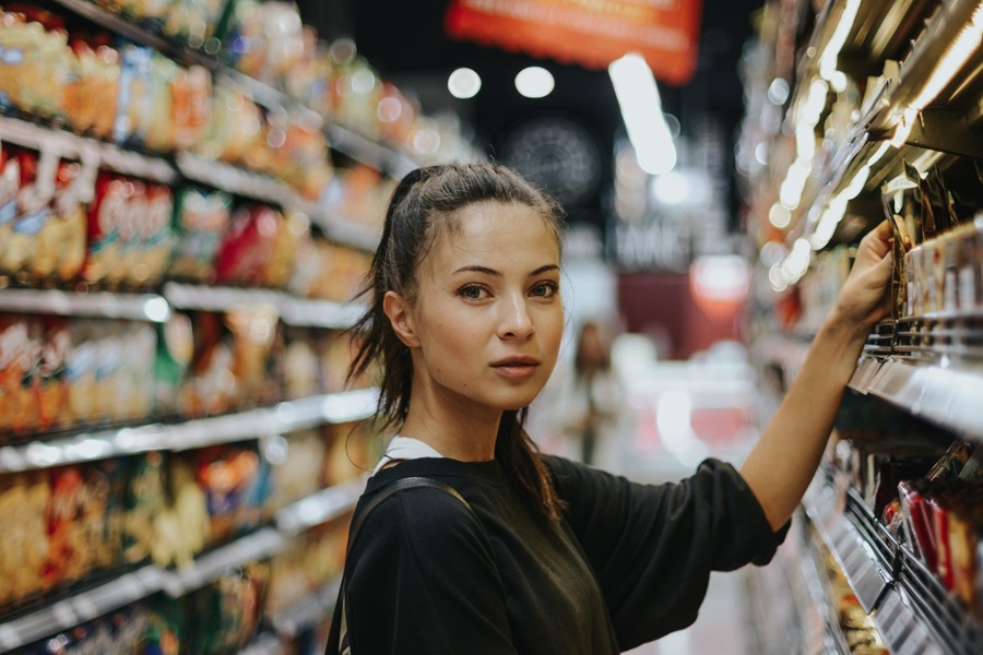 Female shopper selecting product from shelf