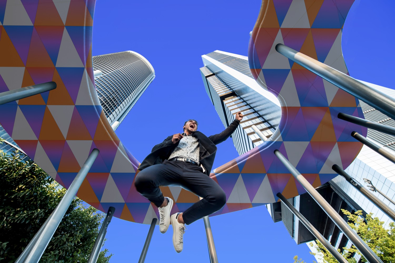 Person jumping beneath colourful architectural structures