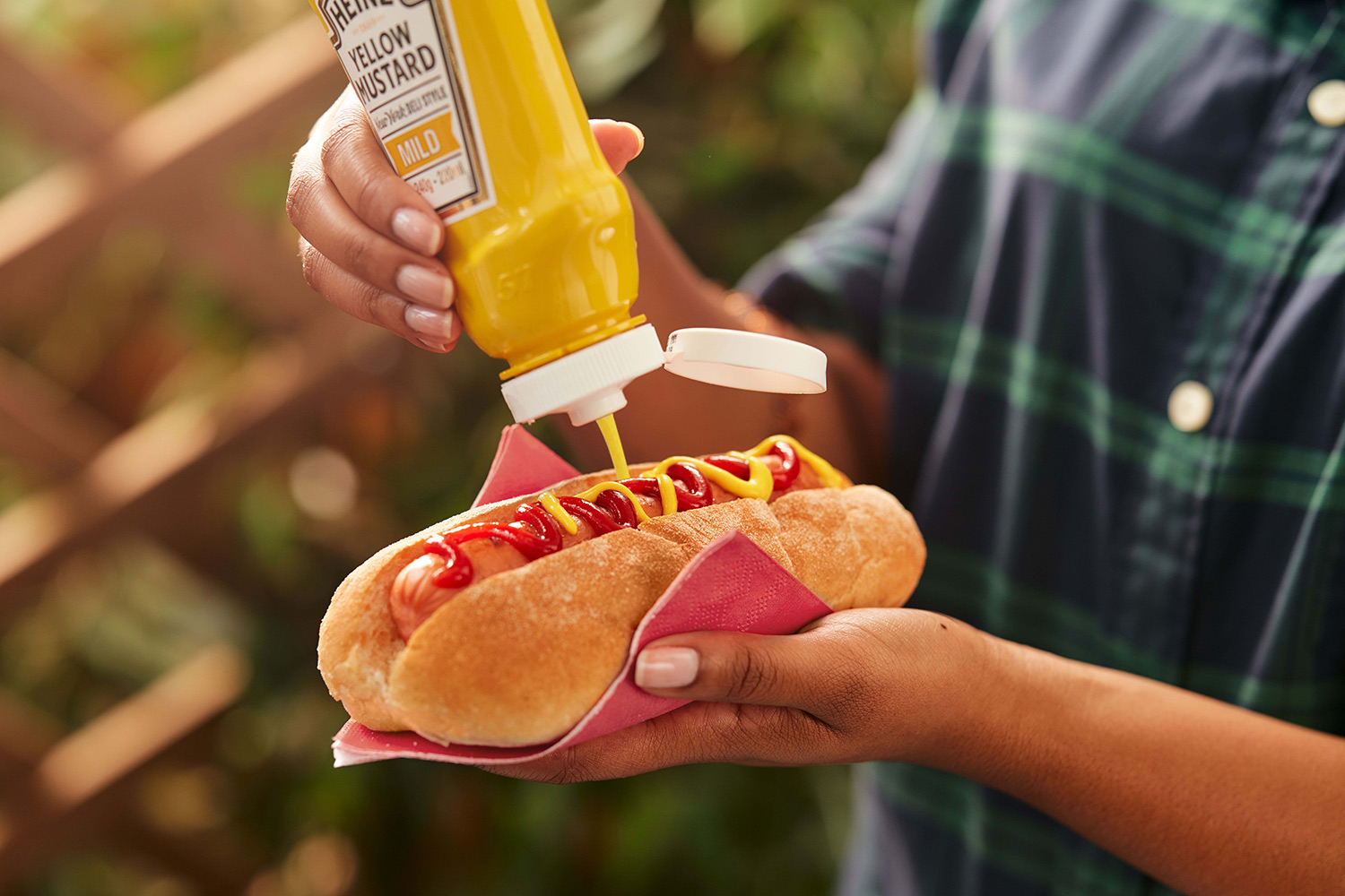 Squirting mustard on a hotdog