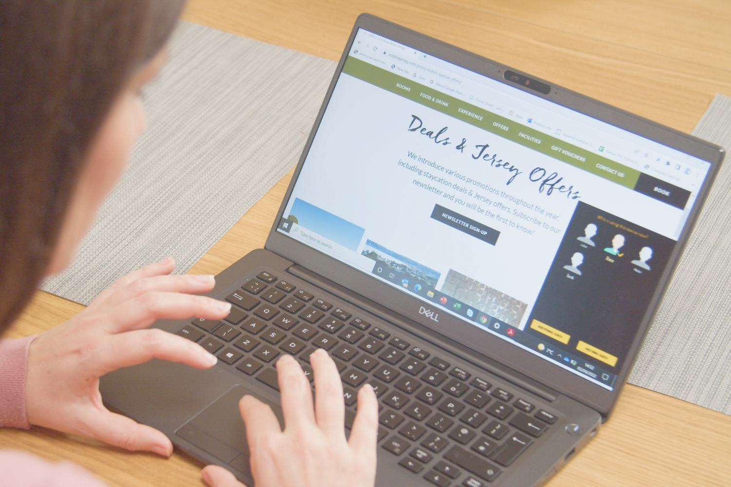 A woman using a laptop with a panel identifier pop up on the screen