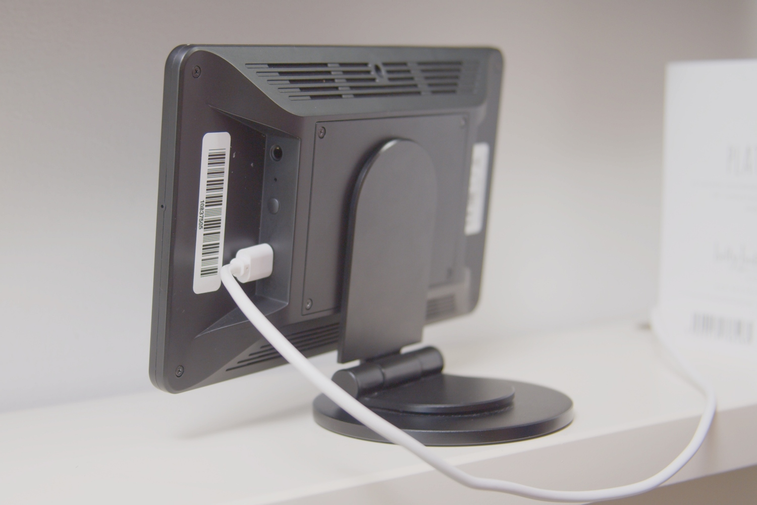 A wire plugged into the back of a charging device. 