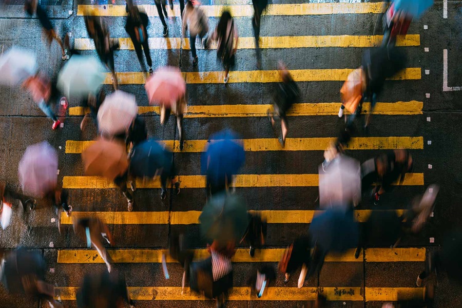 Long exposure of people walking over zebra crossing