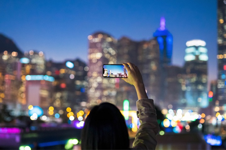 person photographing cityscape