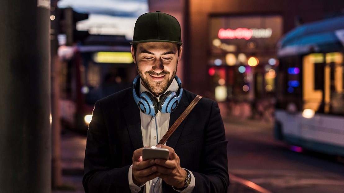 Man holding phone at night 