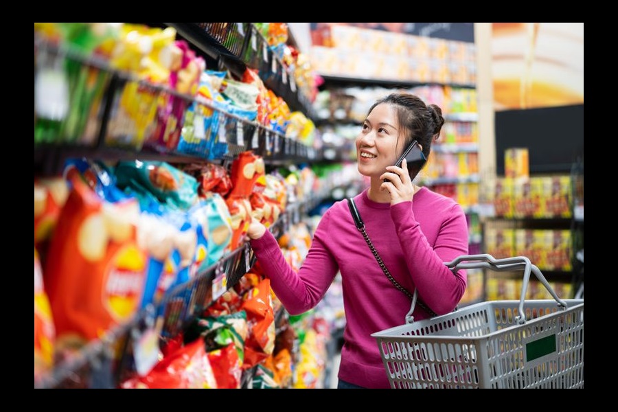 East Asian woman shopping in supermarket