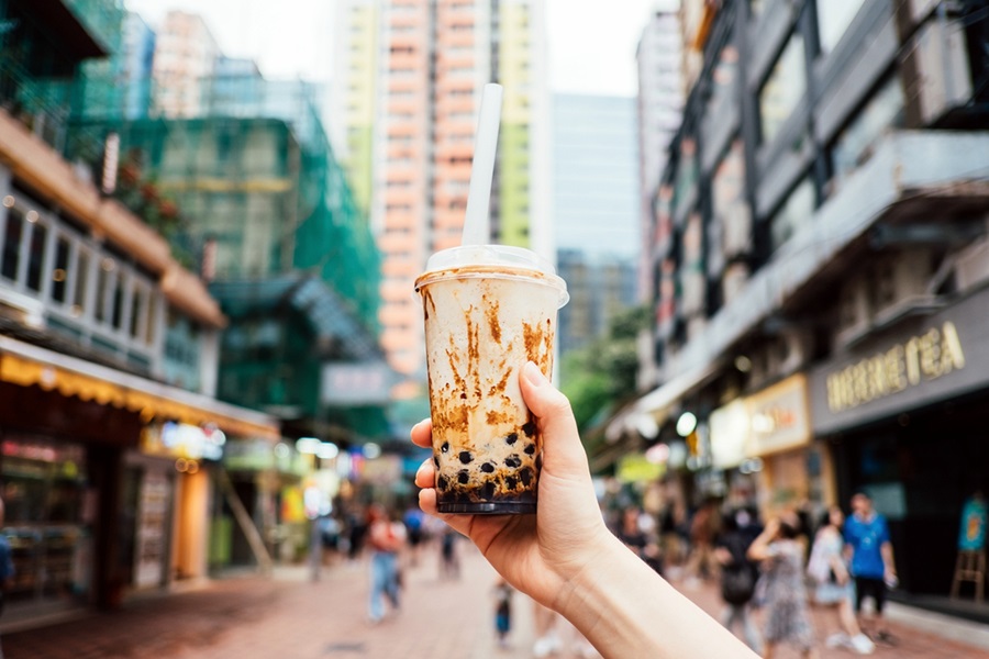 Human hand holding a bottle of iced cold bubble tea