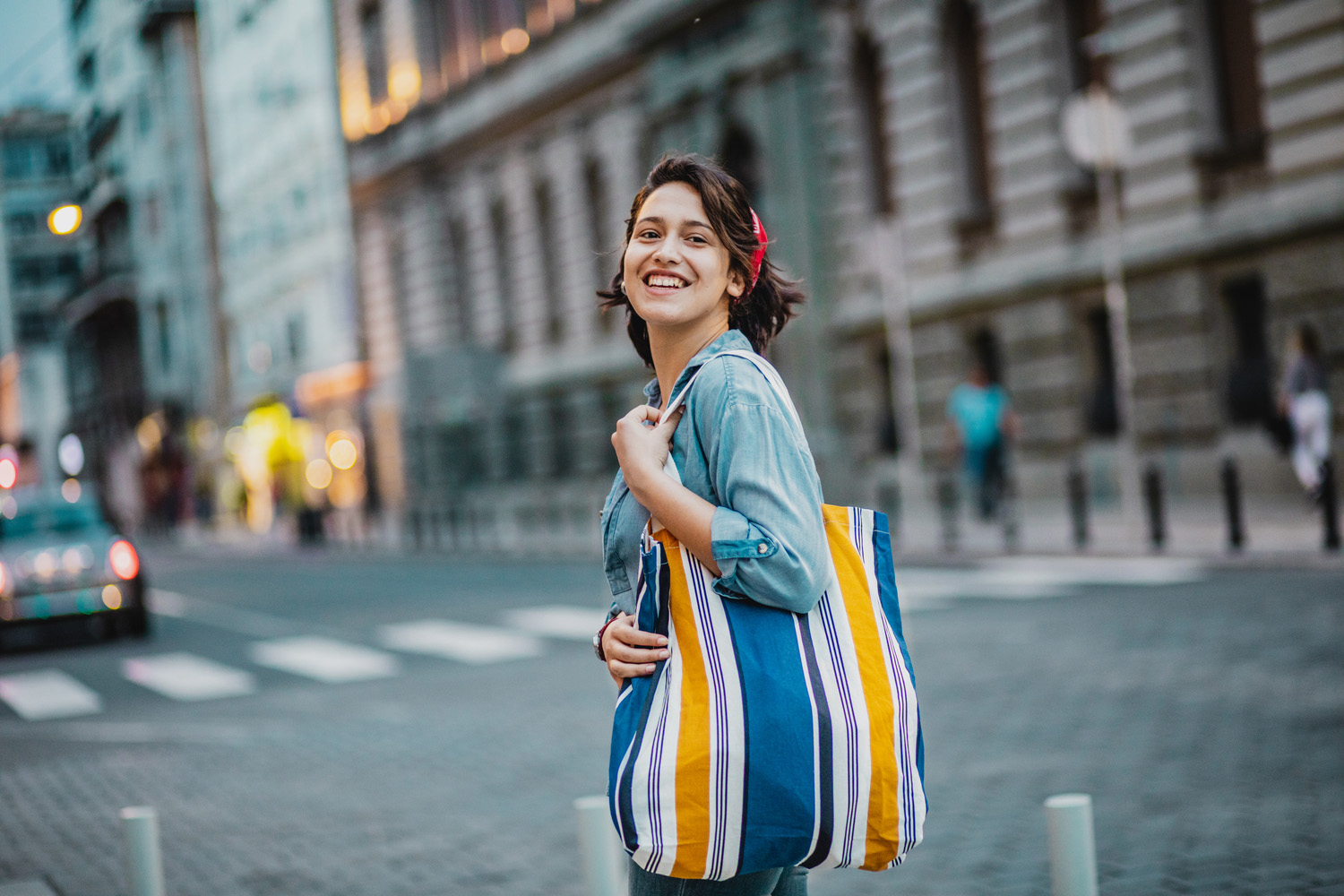 Portrait of smiling woman with reusable shopping bag