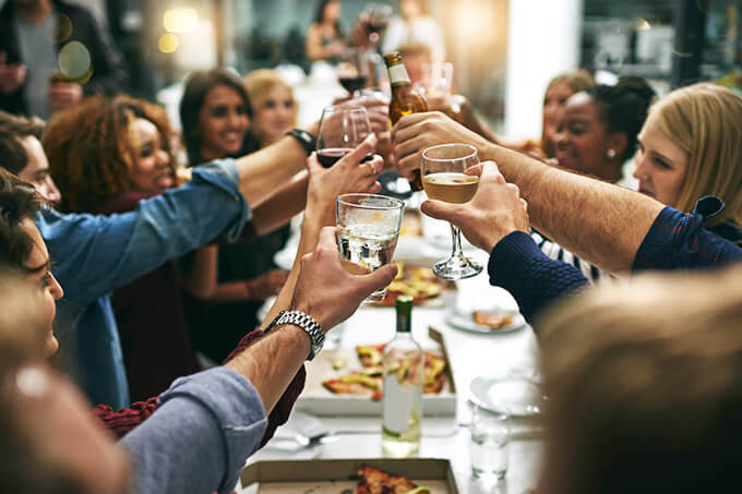 A group of friends raise their glasses in celebration