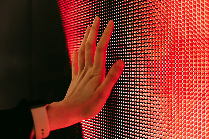 Hand touching a digital screen