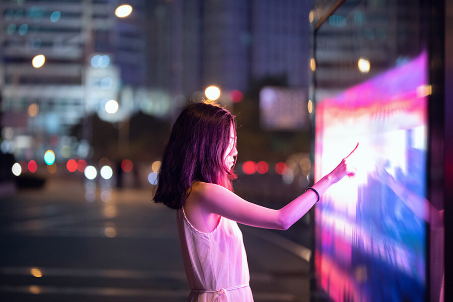 Woman touching a screen with fast moving images