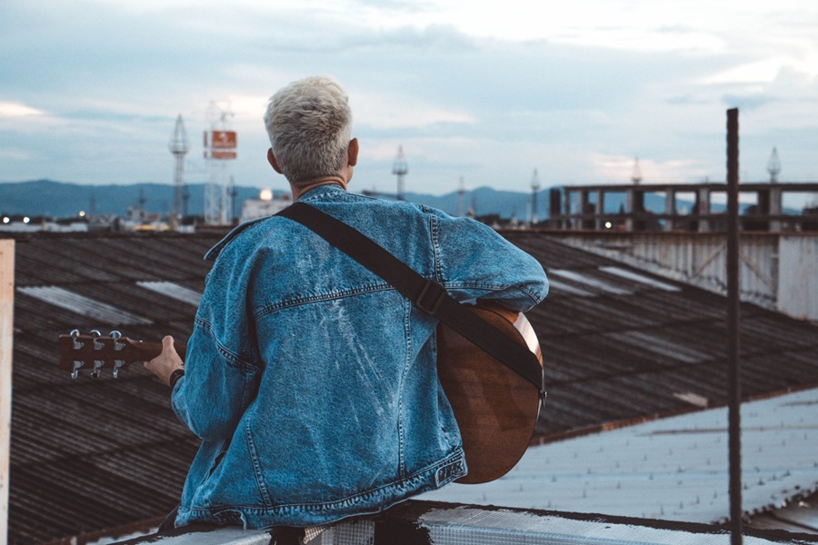 Person playing guitar on rooftop