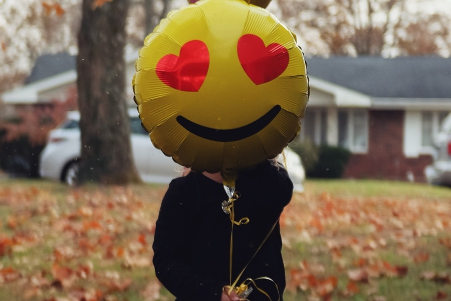 Person with smiley balloon