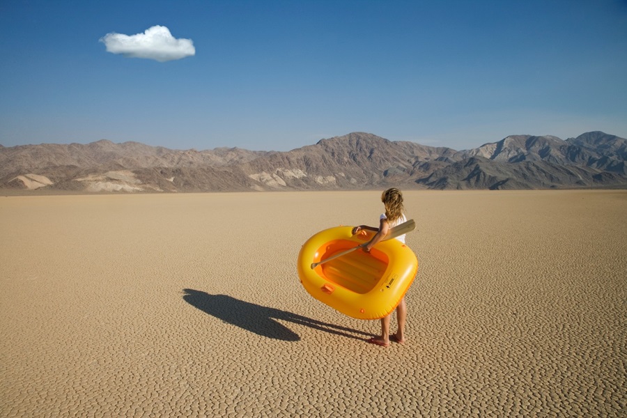 Woman with boat in desert