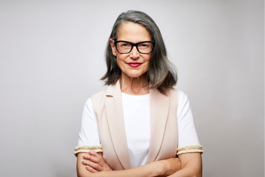 Older business woman arms crossed