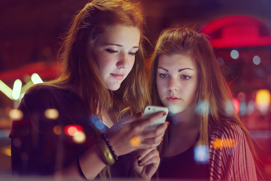 Two girls looking at mobile